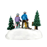 Lemax Family Ski Day Christmas table accent featuring a family skiing scene with snow-covered trees and festive holiday details.