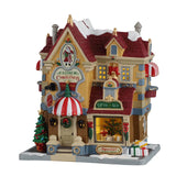 Lemax Father Christmas Gift Shop illuminated building from the Christmas Village collection, featuring festive holiday details.