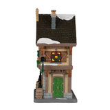 Lemax illuminated building decorated for Christmas, featuring J. Spritzer's Holiday Libations and Wines in a festive village scene