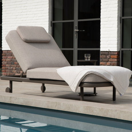 4 Seasons Outdoor Milano Terre sunbed in latte with cushion and headrest, metal outdoor furniture for relaxing in the sun.
