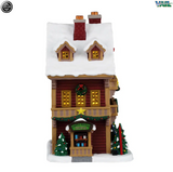Lemax Mountain View Hotel illuminated building from Christmas village display, featuring detailed architecture and festive lighting.