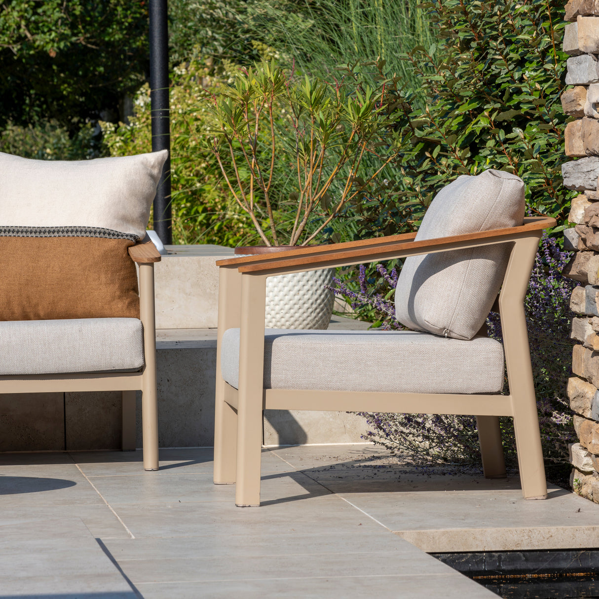 4 Seasons Outdoor Olivia lounge set with Vic coffee table and footstool, featuring metal frame and outdoor cushioned seating.
