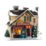 Lemax Penelope's Pies illuminated Christmas village building with festive holiday decorations and detailed design.