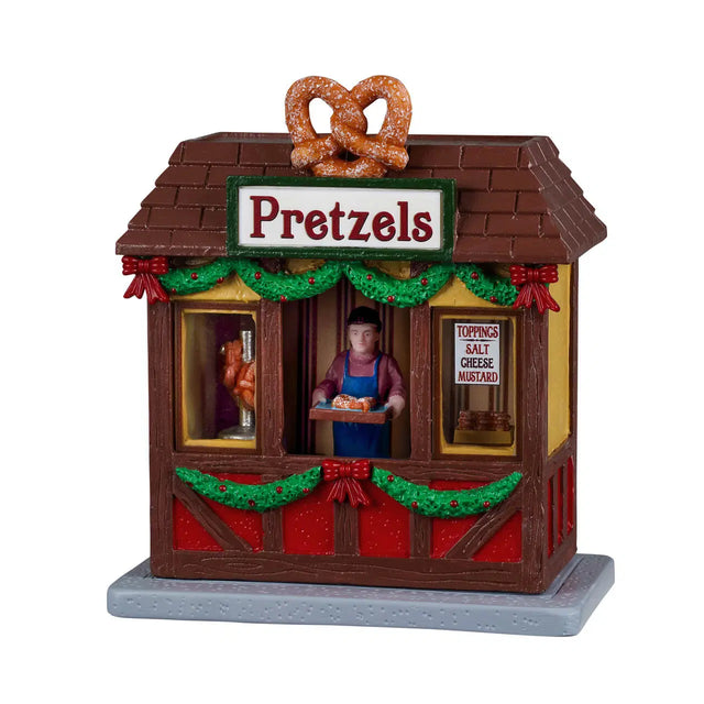 Lemax Christmas Village table accent featuring miniature pretzels with festive holiday decorations and detailed craftsmanship.