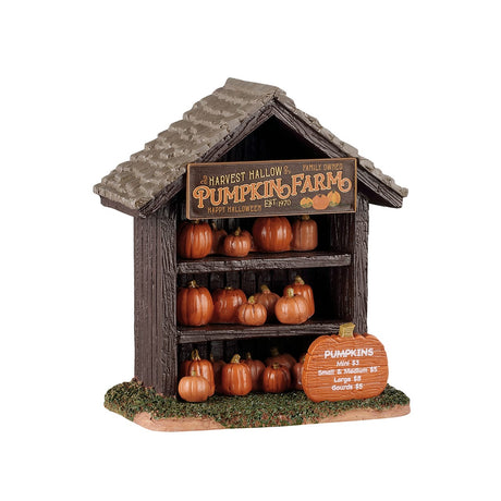 Lemax Spooky Town Pumpkin Shop table accent with carved pumpkin decorations and spooky Halloween details.