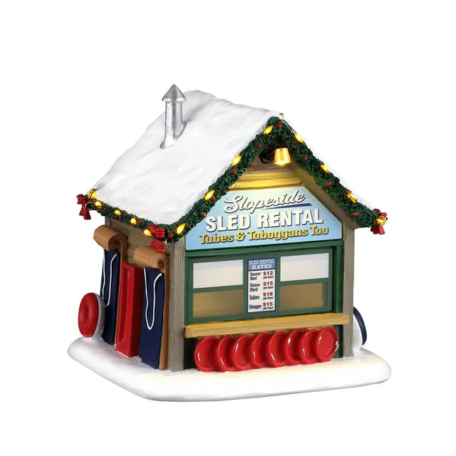 Lemax Slopeside Sled Rental Christmas village table accent with miniature sled and winter scene details.
