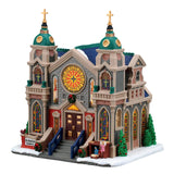 Lemax illuminated St. Stanislaus Cathedral building from the Christmas village display with detailed architecture and festive lighting.