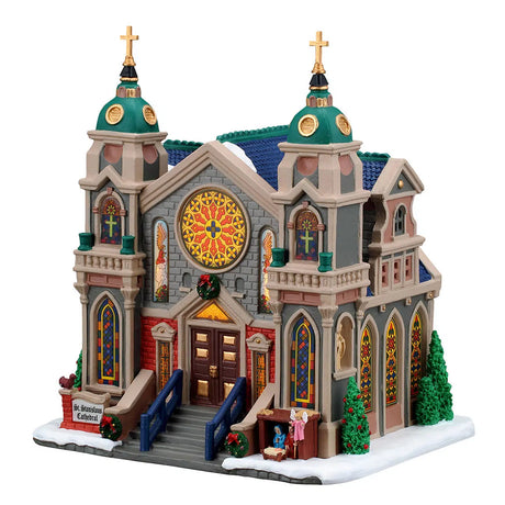 Lemax illuminated St. Stanislaus Cathedral building from the Christmas village display with detailed architecture and festive lighting.