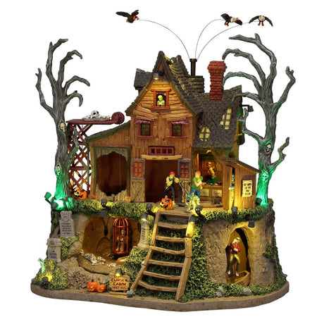 Lemax Spooky Town The Cursed Cabin model with sights and sounds, featuring a spooky cabin scene with detailed decorations and lighting.