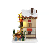 Lemax The Cocoa Shanty Christmas village illuminated building with festive holiday details and warm lighting.