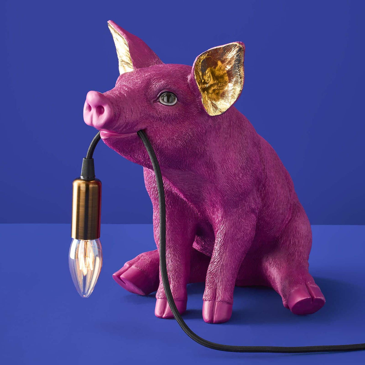 Werner Vob WERNS Piggy Pig table lamp in vibrant magenta, quirky indoor lighting with a playful pig design.