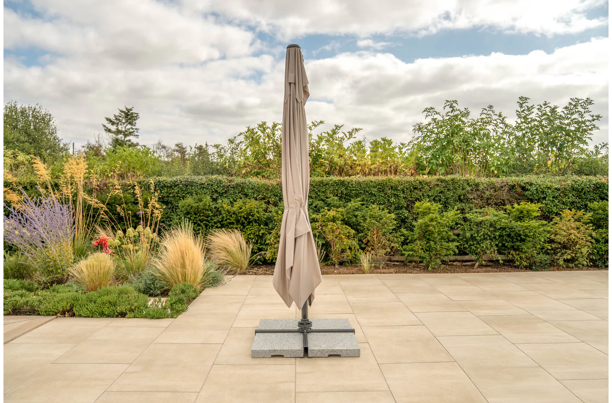 Kettler Luna 3x3M square cantilever parasol with taupe canopy, granite base, and night cover for outdoor furniture shading.