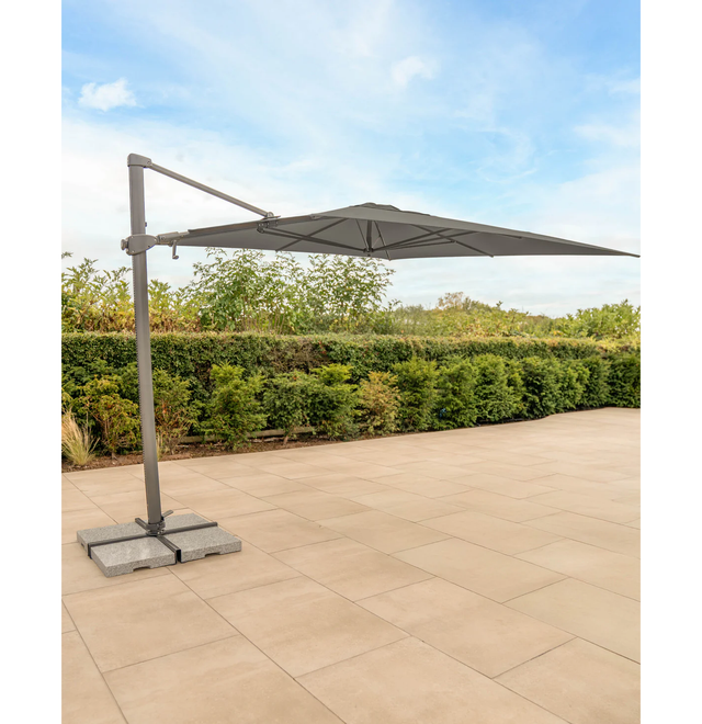Kettler Luna 3x3M square cantilever parasol with taupe canopy, granite base, and night cover, providing shade and outdoor style.