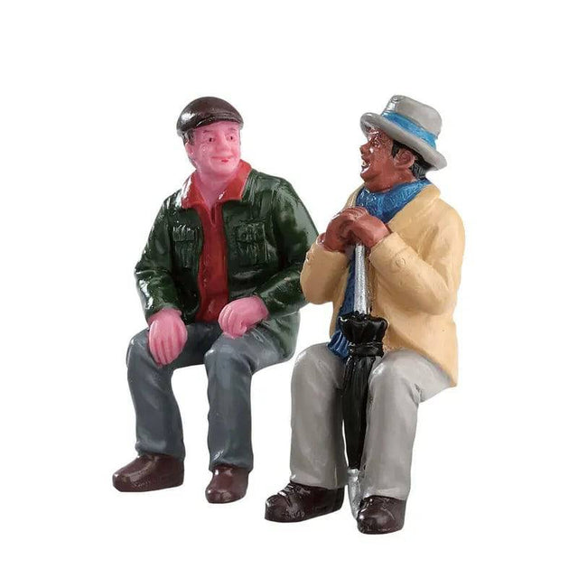 Set of 2 Lemax Christmas Village figurines depicting old friends chatting, detailed holiday-themed scene with festive attire.