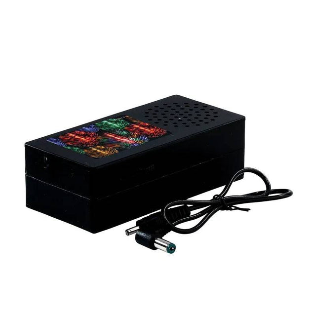 Lemax Christmas Village accessory featuring a firework soundbox with festive lights and detailed holiday scene.