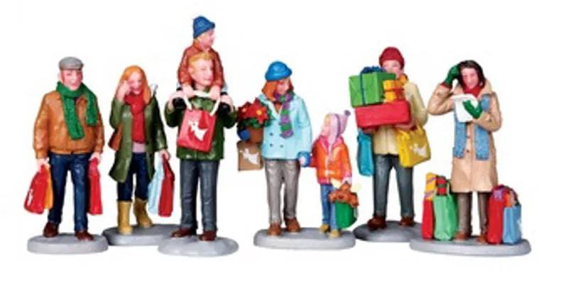 Six Lemax Christmas village figurines featuring holiday shoppers, detailed festive characters for holiday village display.